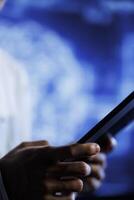 Programmer writes code on tablet to visualize artificial intelligence neural networks using augmented reality, close up. Qualified employee runs AI script for information processing photo