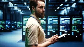 Technician ensuring proper functioning of VPN servers with top security standards used to adequately protect sensitive data. High tech infrastructure providing reliable internet connections for users photo