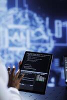 Trained developer updates neural networks made up of interconnected nodes, writing intricate binary code scripts on tablet. Expert uses programming to upgrade AI simulation model, blurry background photo