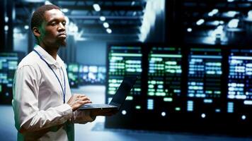 Engineer walking through cryptocurrency mining facility server rows solving complex mathematical equations. Expert in data center housing blockchain technology high volume real time transactions photo