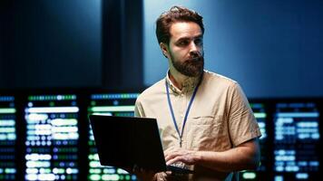 Specialist upgrading server room security to protect information access, making sure virus protection software is up to date and hackers trying to penetrate systems are rebuffed photo