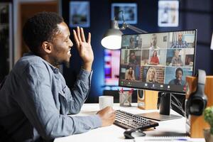 Male student participating in online e learning program with trainer, listening to class lesson about startup duties administration. Person attending training course on videocall. photo