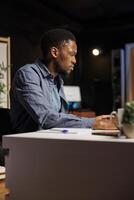 Ambitious pupil acquires knowledge in business administration via web based training program, focusing on webinar with certified mentor. Young man decided to study banking and commerce. photo
