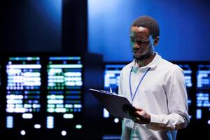 Technician doing annual maintenance, helping prolong equipment life span and avoiding downtime. Admin monitoring server hardware components for issues such as overheating or power fluctuations photo