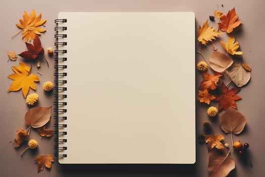 An open notebook lies on a surface, surrounded by various colorful flowers and leaves around it. photo