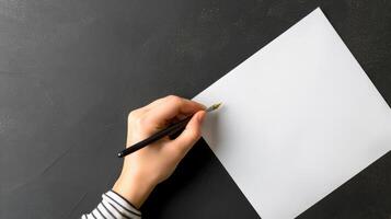 Person writing by left hand on white blank photo