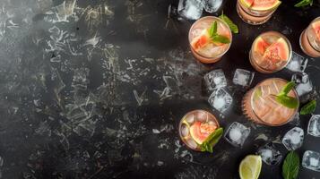 Top view of Paloma cocktail in glasses with tropical guava fruit and ice cubes . Summer vacation illustration with copy space on dark background. Perfect for summer menus and restaurant business photo