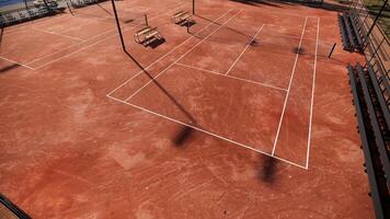 aerial view of tennis court with red clay surface include net, lights, spectator seats photo