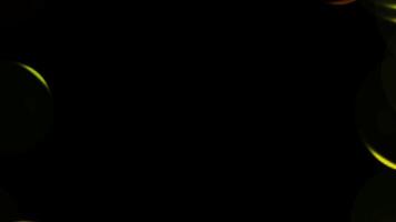 a black background with yellow and green circles video