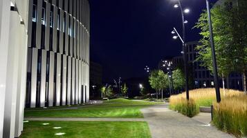 Pattern of office buildings windows illuminated at night. Glass architecture ,corporate building at night - business concept. photo