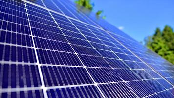 Group of solar panels on a blue sky. Concept of solar energy. photo