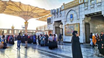 Medina, Saudi Arabia on March 1, 2024. Queues of female Umrah pilgrims from all over the world line up to enter Raudhah or the Tomb of the Prophet Muhammad. Gate 37. Use a registered Tasreh or Nusuk. photo