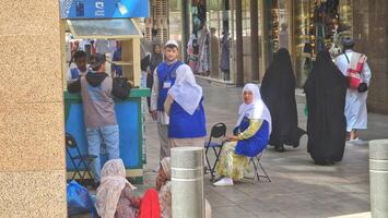Medina, Saudi Arabia on March 3 2024. Female Umrah pilgrims are buying internet data packages at the Mobily counter, so they can stay connected with their families in their hometowns. GIGABYTES. photo