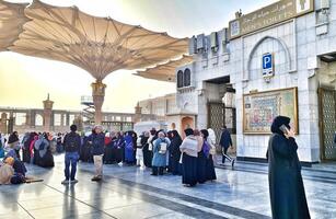Medina, Saudi Arabia on March 1, 2024. Queues of female Umrah pilgrims from all over the world line up to enter Raudhah or the Tomb of the Prophet Muhammad. Gate 37. Use a registered Tasreh or Nusuk. photo