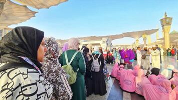 Medina, Saudi Arabia on March 1, 2024. Queues of female Umrah pilgrims from all over the world line up to enter Raudhah photo