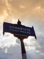 Bangkok, Thailand on July 22, 2023. A street sign, Thanon Maha Rat, Khet Phra Nakhon. photo