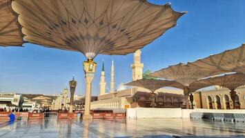 Medina, Saudi Arabia on March 2, 2024. Point of view of an Umrah or Hajj pilgrim walking in the courtyard of the Nabawi Mosque photo