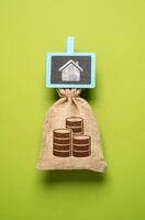 Money bag with savings for the house. Save to buy a house or an apartment. Collect money for dreams and intended purposes. Buy real estate now by taking out a mortgage. photo