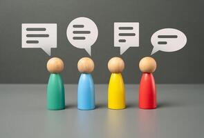 People communicate. Figures of people and speech bubbles. Unity and teamwork. Contact, communication. Exchange of opinions and experiences. photo