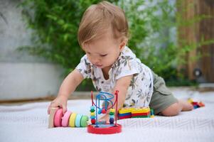 Curious baby playing with colorful toys on a mat photo