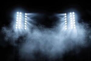 two stadium lights shining through smoke on black background, sports background with fog and lighting effects photo