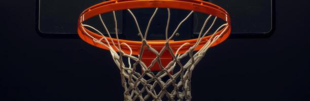 Close-up shot of a basketball hoop with a net against a dark background. Perfect for sports-themed design or promotional material. photo