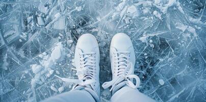 Top view of white ice skates on a frozen ice rink. Perfect for winter sports, ice skating, and outdoor activities imagery. photo