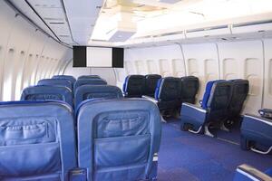 Blue empty seats in the cockpit of an airplane at the start before an air flight. photo