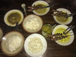 goat satay with curry sauce served with warm rice photo