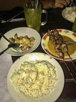 goat satay with curry sauce served with warm rice photo