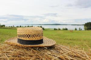 Straw hat on a haystack in a field close-up. Summer mood photo