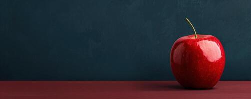 Red apple on wooden table against blue background. photo