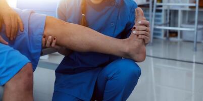Physical therapists work with patients in close-up clinics. The concept of rehabilitation of physical health, the doctor gives advice to the patient. Ankle problems and muscle injuries photo