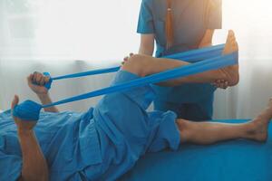 Physical therapists work with patients in close-up clinics. The concept of rehabilitation of physical health, the doctor gives advice to the patient. Ankle problems and muscle injuries photo
