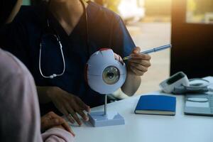 Ophthalmologist in Clinic with Eye Model