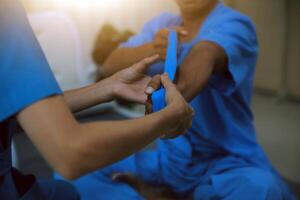 Professional physical therapist examines and cares for a young man in a physical therapy center, treating muscles and injuries of a man in a hospital. photo