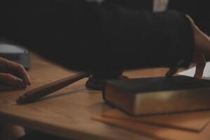 Judge gavel with Justice lawyers having team meeting at law firm background. Concepts of Law and Legal services. photo
