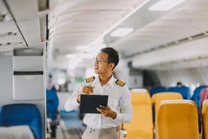 Portrait of a trained airplane captain in uniform preparing to fly in a simulator cockpit. photo