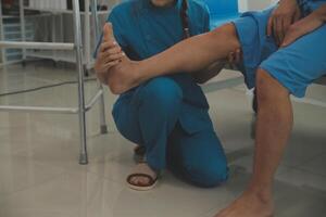 Physical therapists work with patients in close-up clinics. The concept of rehabilitation of physical health, the doctor gives advice to the patient. Ankle problems and muscle injuries photo