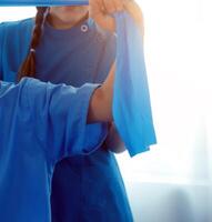 Close up hand patient doing stretching exercise with a flexible exercise band and a physical therapist hand to help in clinic room. photo