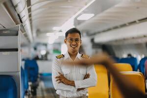 Portrait of a trained airplane captain in uniform preparing to fly in a simulator cockpit. photo