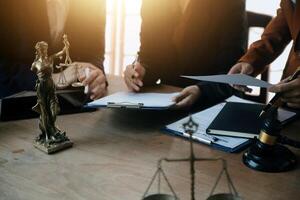 Lawyer, legal advisor, businessman brainstorming information on agreement details Business contracts in legal processing books for accuracy in contract documents. joint financial investment. photo