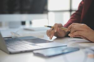 Cropped image of professional businesswoman working at her office via laptop, young female manager using portable computer device while sitting at modern loft, flare light, work process concept photo