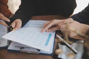 Lawyer, legal advisor, businessman brainstorming information on agreement details Business contracts in legal processing books for accuracy in contract documents. joint financial investment. photo