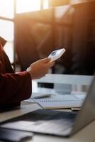 Cropped image of professional businesswoman working at her office via laptop, young female manager using portable computer device while sitting at modern loft, flare light, work process concept photo