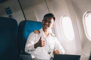 Portrait of a trained airplane captain in uniform preparing to fly in a simulator cockpit. photo