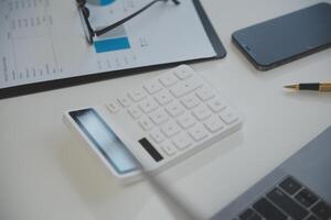 Laptop computer with opened lid on table in meeting room of office workspace. photo