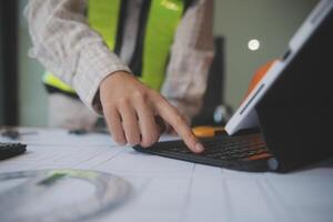 engineer people meeting working and pointing at a blueprint in office for discussing. Engineering tools and construction concept photo