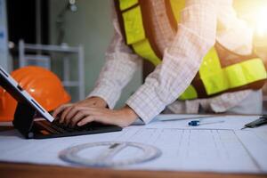 engineer people meeting working and pointing at a blueprint in office for discussing. Engineering tools and construction concept photo