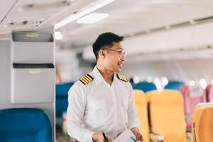 Portrait of a trained airplane captain in uniform preparing to fly in a simulator cockpit. photo